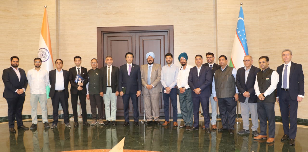 Uzbekistan Tech and Trade movement — a group portrait with Indian and Uzbek flags after a round-table session.